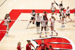 Members of the UW women’s volleyball team celebrate the match-winning point as the team completes their 3-0 sweep and upset of the #1 ranked Nebraska Cornhuskers during the 2023 regular season.